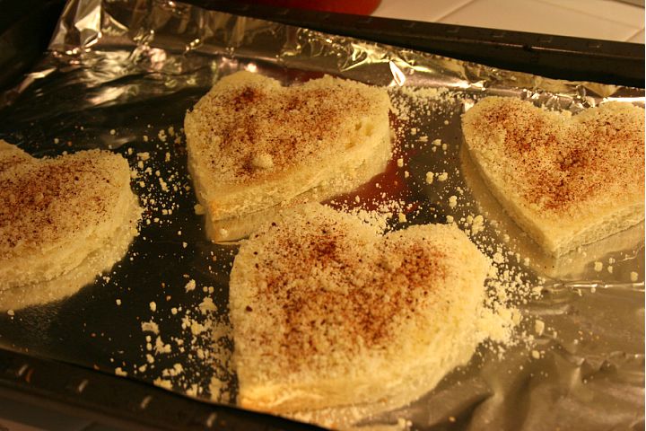 Heart shaped toast on a pan