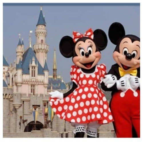 mickey and minnie mouse in front of castle