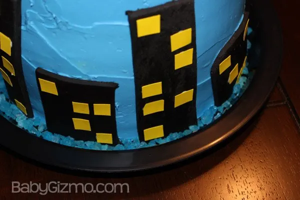 Close up of a city of fondant on a batman cake