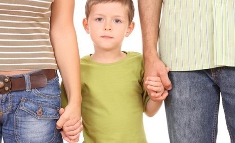 little boy holding parents hands