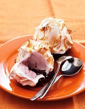 baked alaska on a plate with two spoons