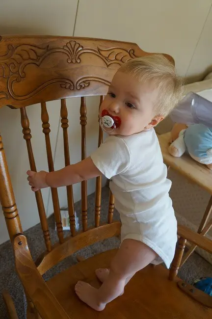 baby boy standing on chair
