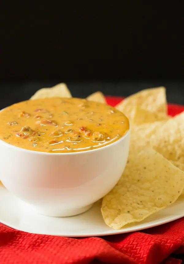 queso dip with chips on plate