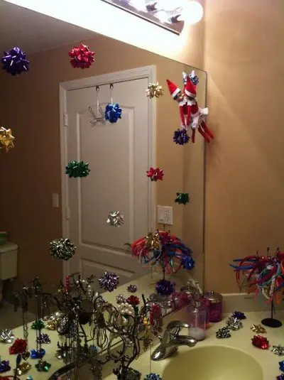 elf hanging from bathroom mirror