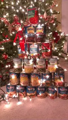 elf on the shelf stack of cans