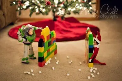 baby elf on the shelf plays with toy story