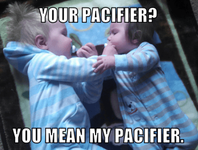 twins with pacifiers
