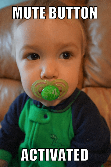 baby with green pacifier