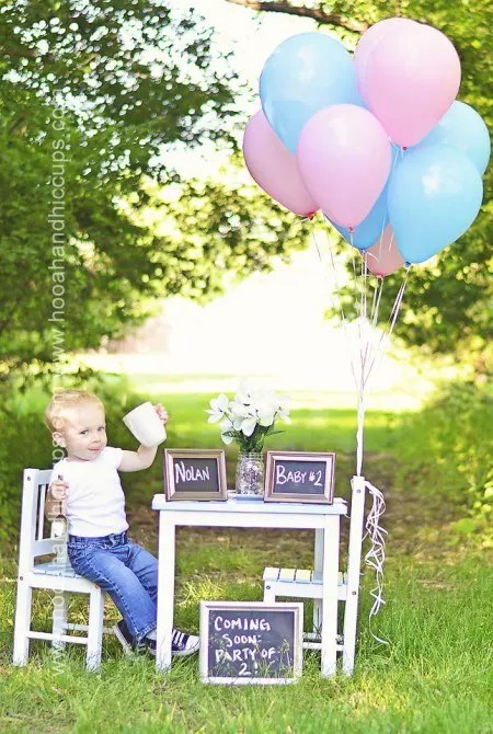 little boy with pink and blue balloons