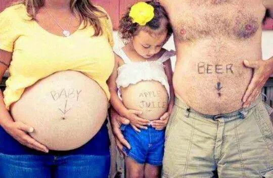 mom dad and little girl showing bellies