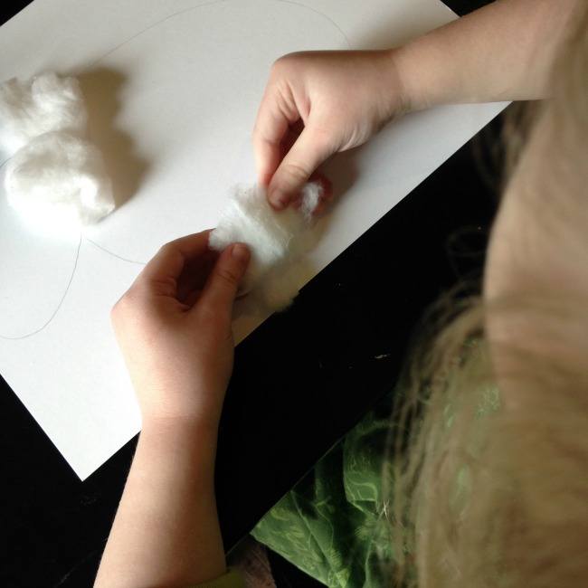 toddler crafting with cotton balls