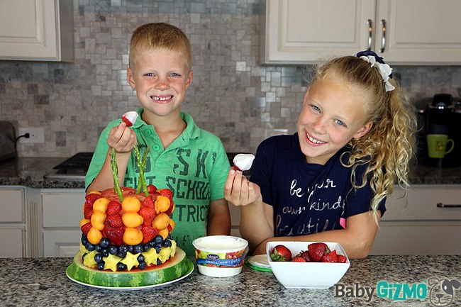 two kids doing a fruit craft