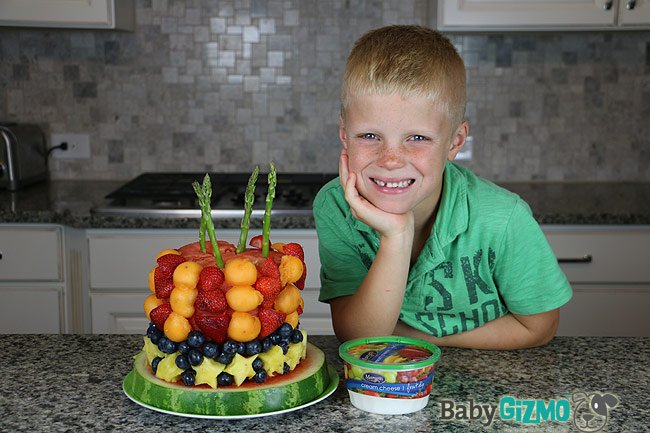 cute boy next to fruit craft