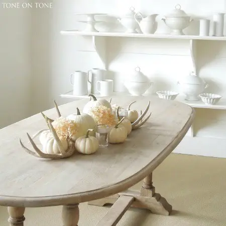 white kitchen with white pumpkins on table