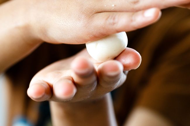 child rolling dough