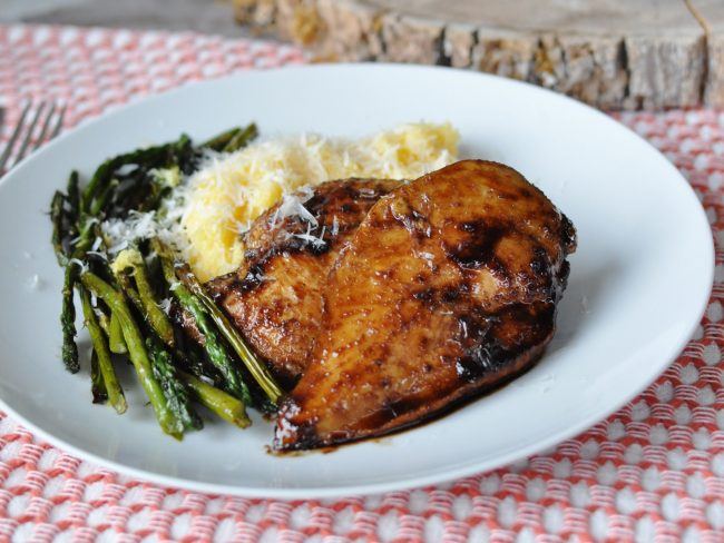 citrus chicken with asparagus on a plate