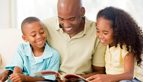 dad with two kids reading