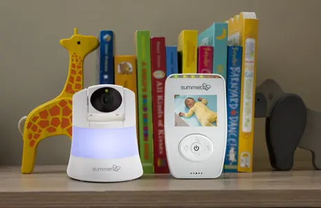 Baby monitor sitting on a book shelf