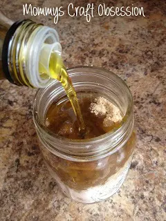 adding oil into sugar mason jar