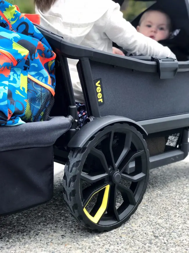 baby peeking out of the veer wagon