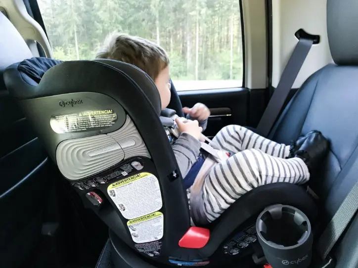 baby in car seat looking out window