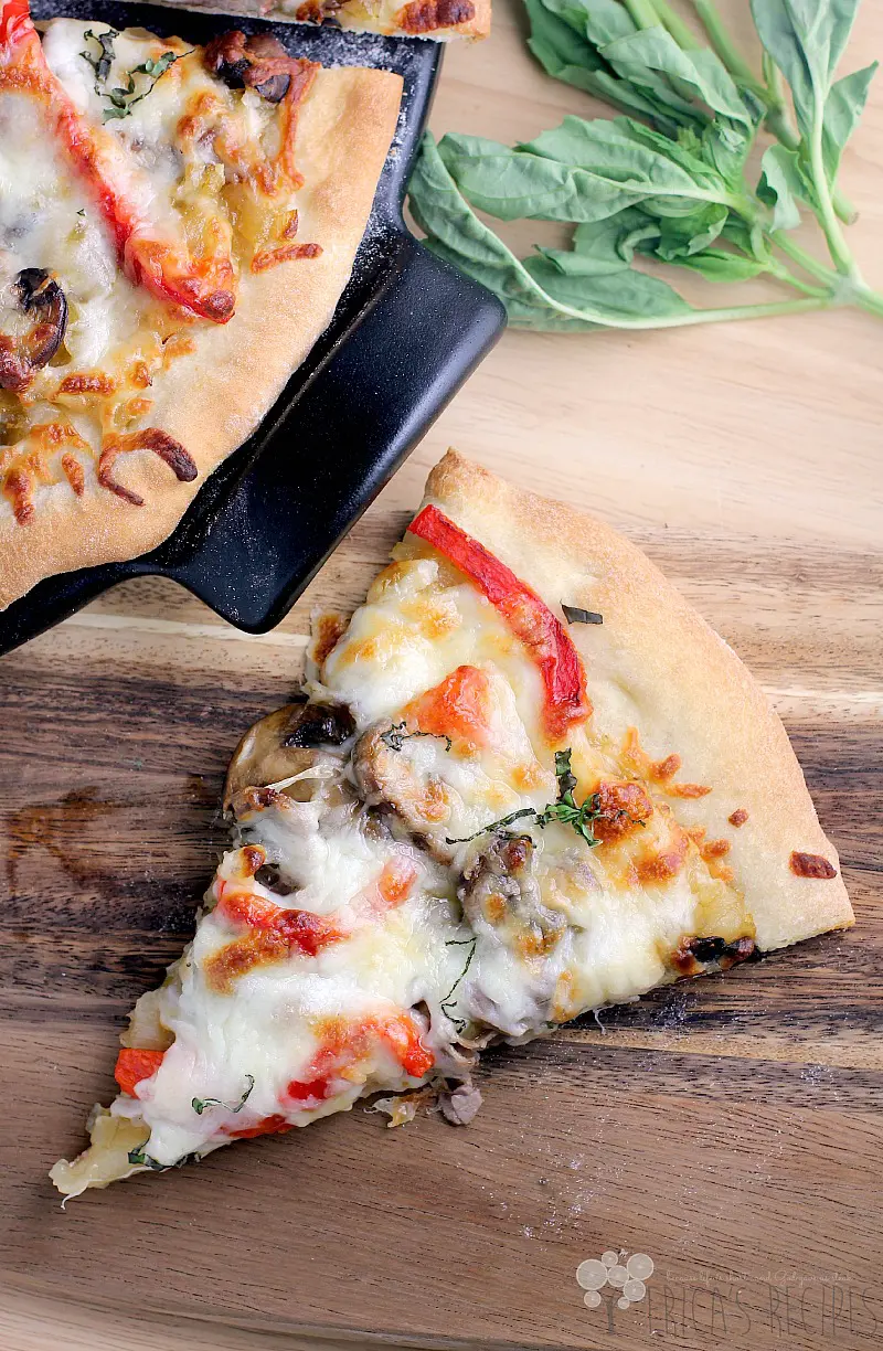 piece of french onion pizza on a cutting board