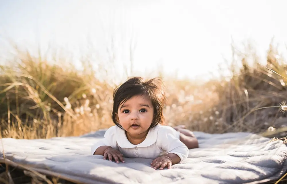 baby laying on mat