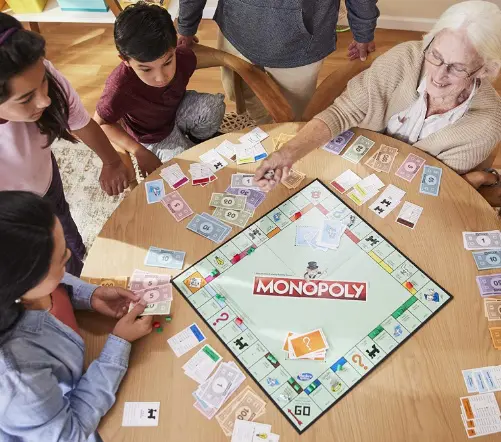 family playing monopoly around a table