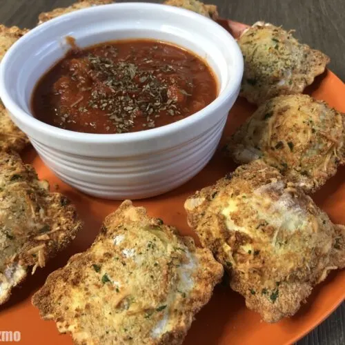 air fried toasted ravioli on orange plate