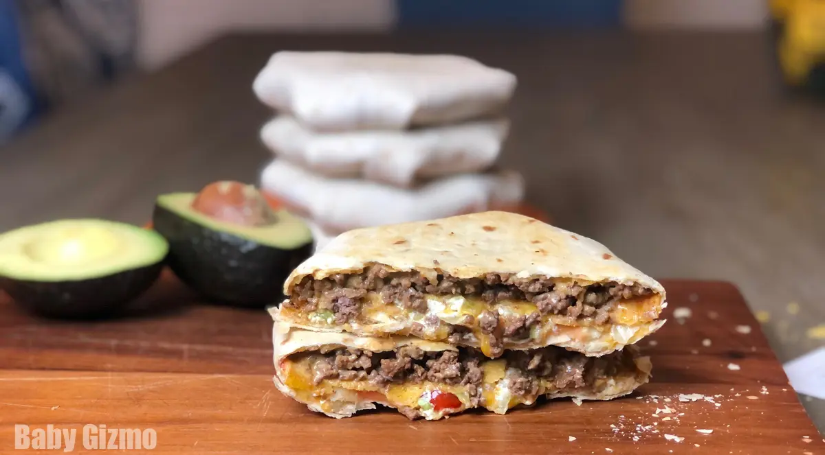 Crunchwrap cut in half on cutting board