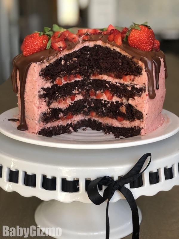 dark chocolate strawberry cake on a cake stand