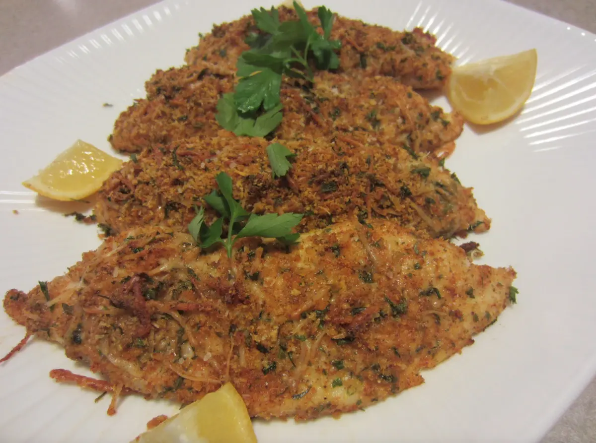 parmesan crusted tilapia on a white plate