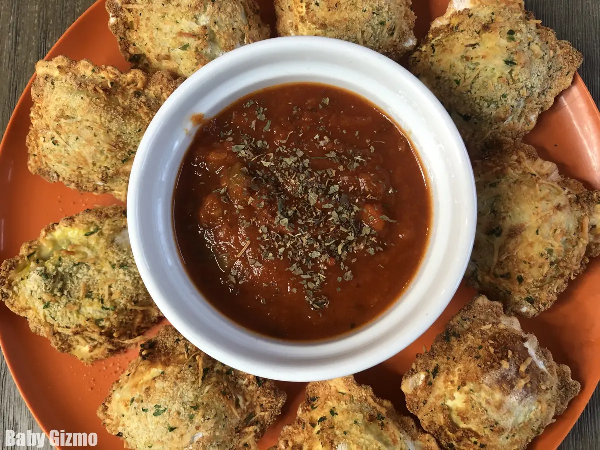 Close up of toasted ravioli with sauce