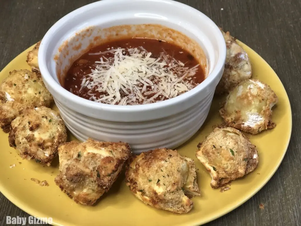 Toasted Tortellini on yellow plate with sauce