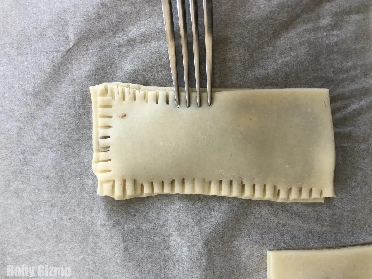 Sealing pie dough with a fork