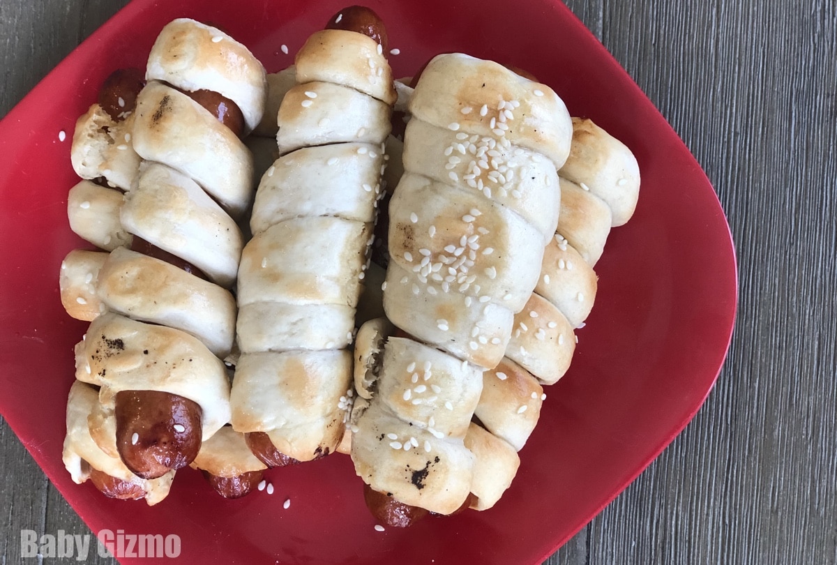 pretzel hot dogs on red plate