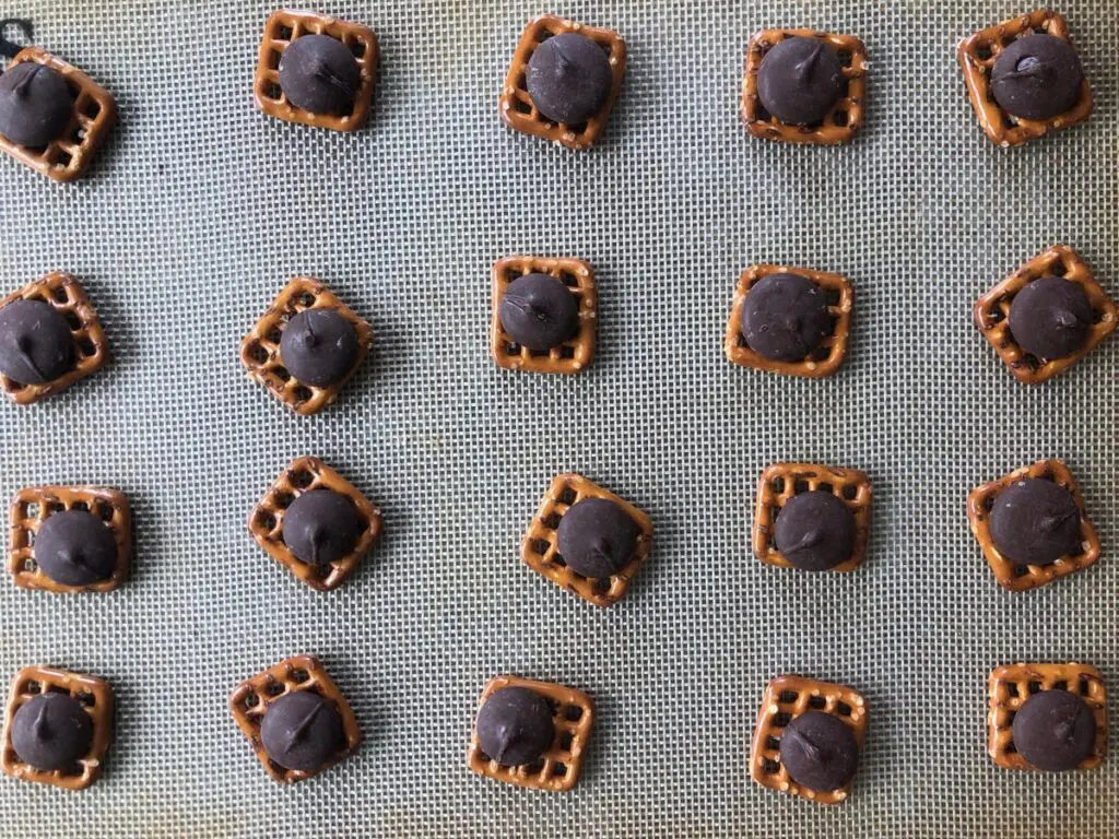 pretzels and chocolate on a baking sheet