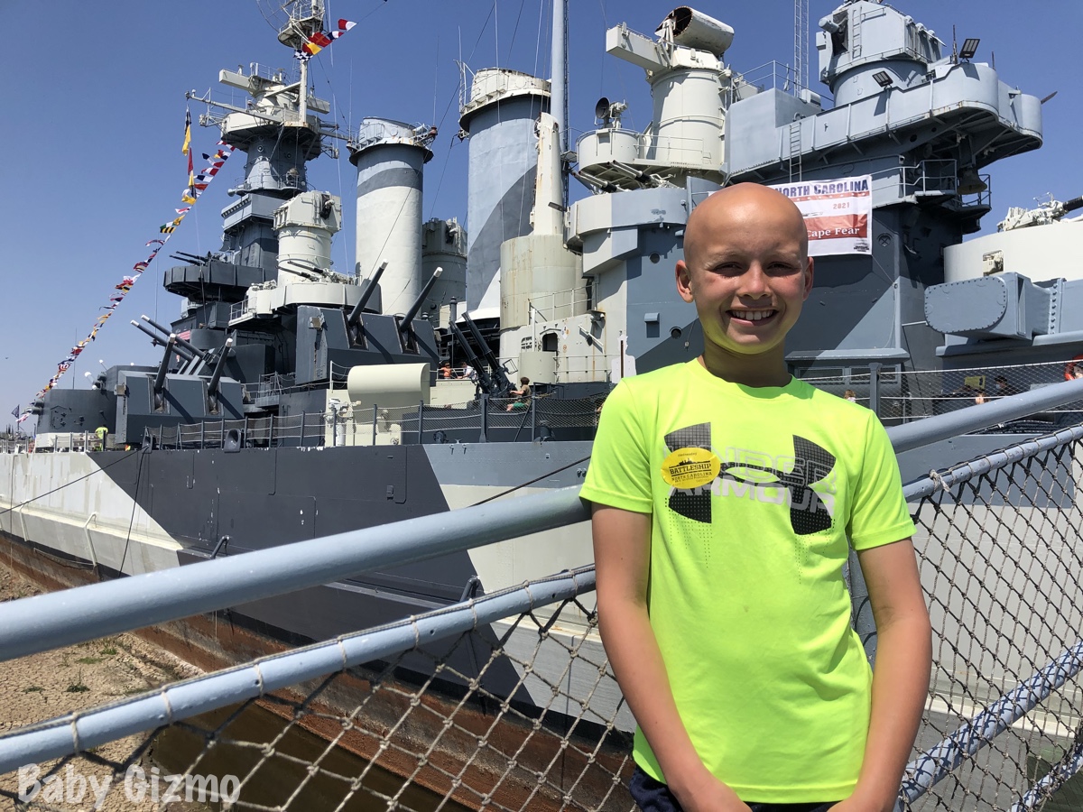 boy in front of wilmington battleship