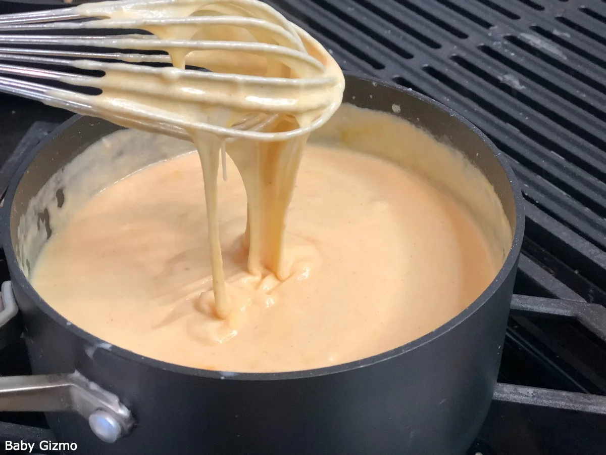 Mac and Cheese Sauce in a pan with a whisk