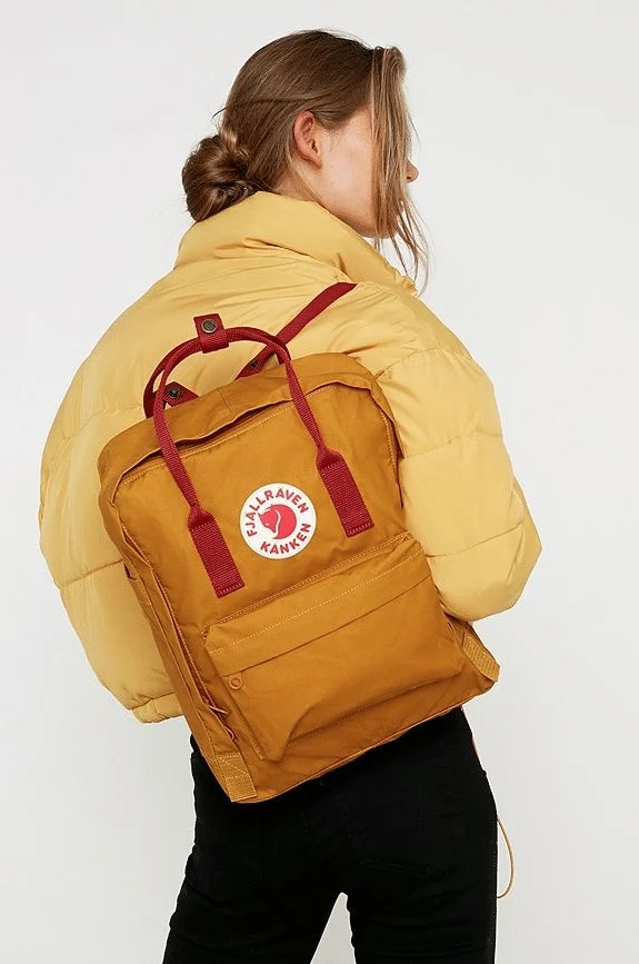 model holding fjallraven kanken backpack