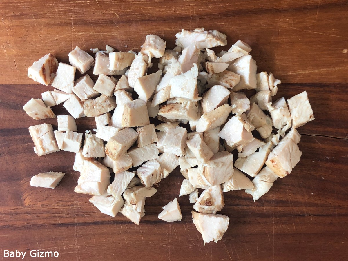chopped chicken pieces on cutting board