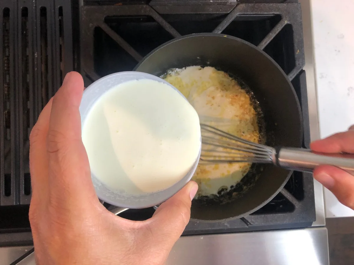adding cream to butter mixture in pot