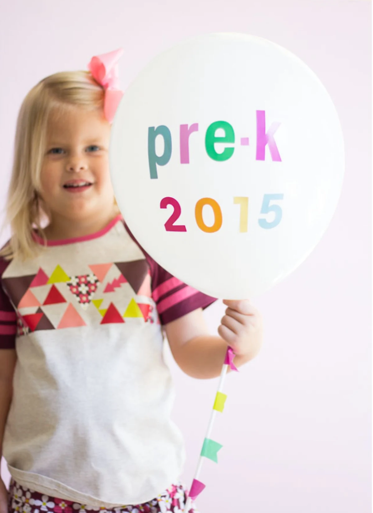 little girl holding balloon