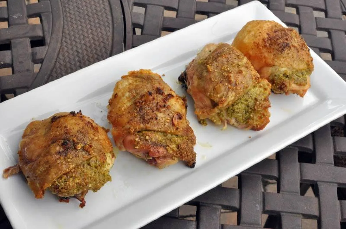 pesto roasted chicken thighs on a white plate 