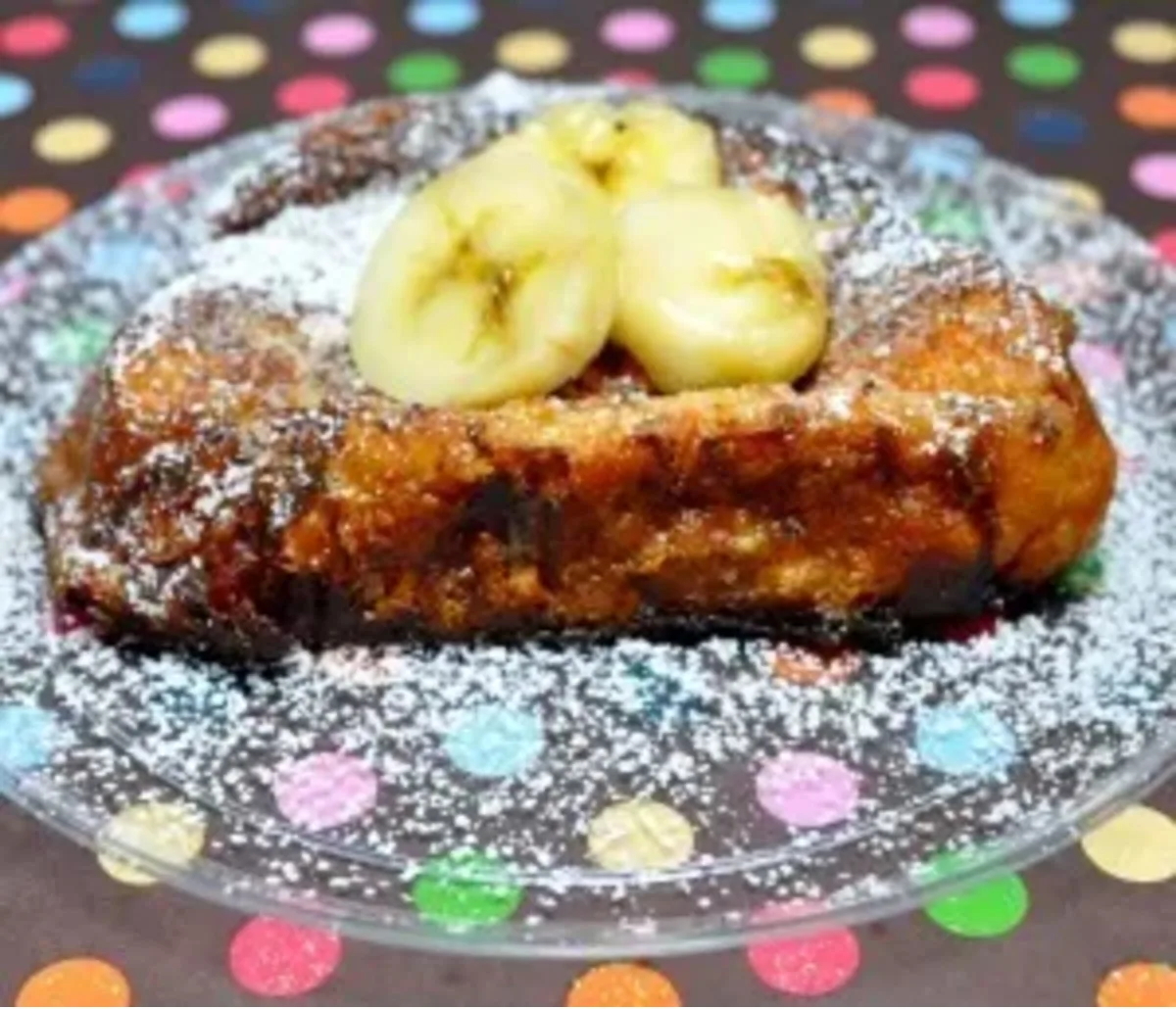 Chocolate & Banana Stuffed French Toast on a glass plate with poka dots