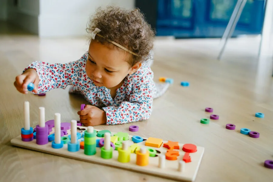 baby girl playing with letters