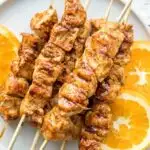 orange chicken skewers on plate