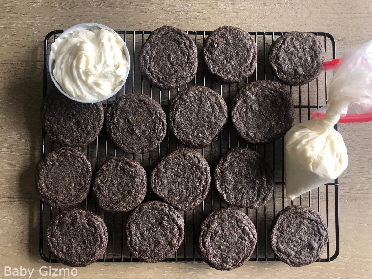Oreo Cookies with frosting on a cooling rack
