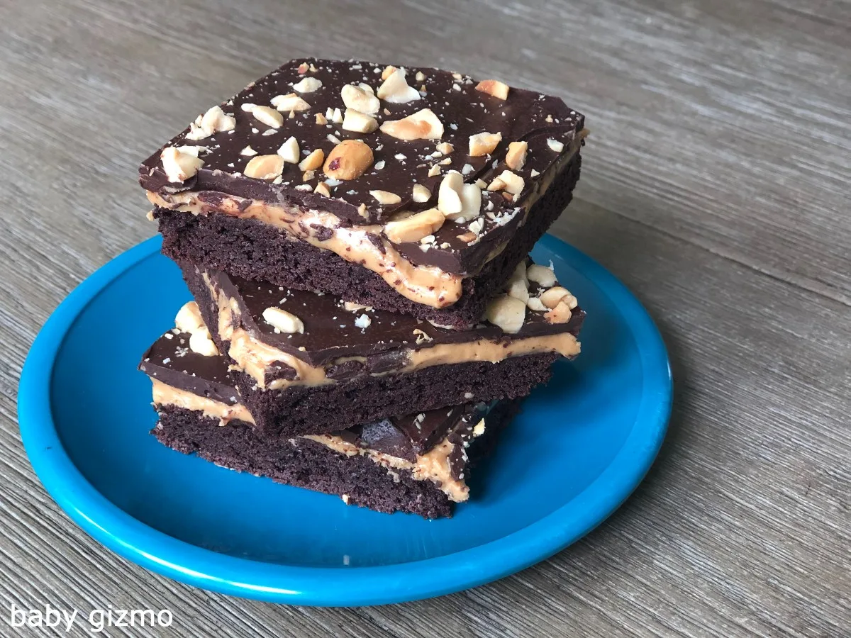 peanut butter cup cookie bars stacked on blue plate
