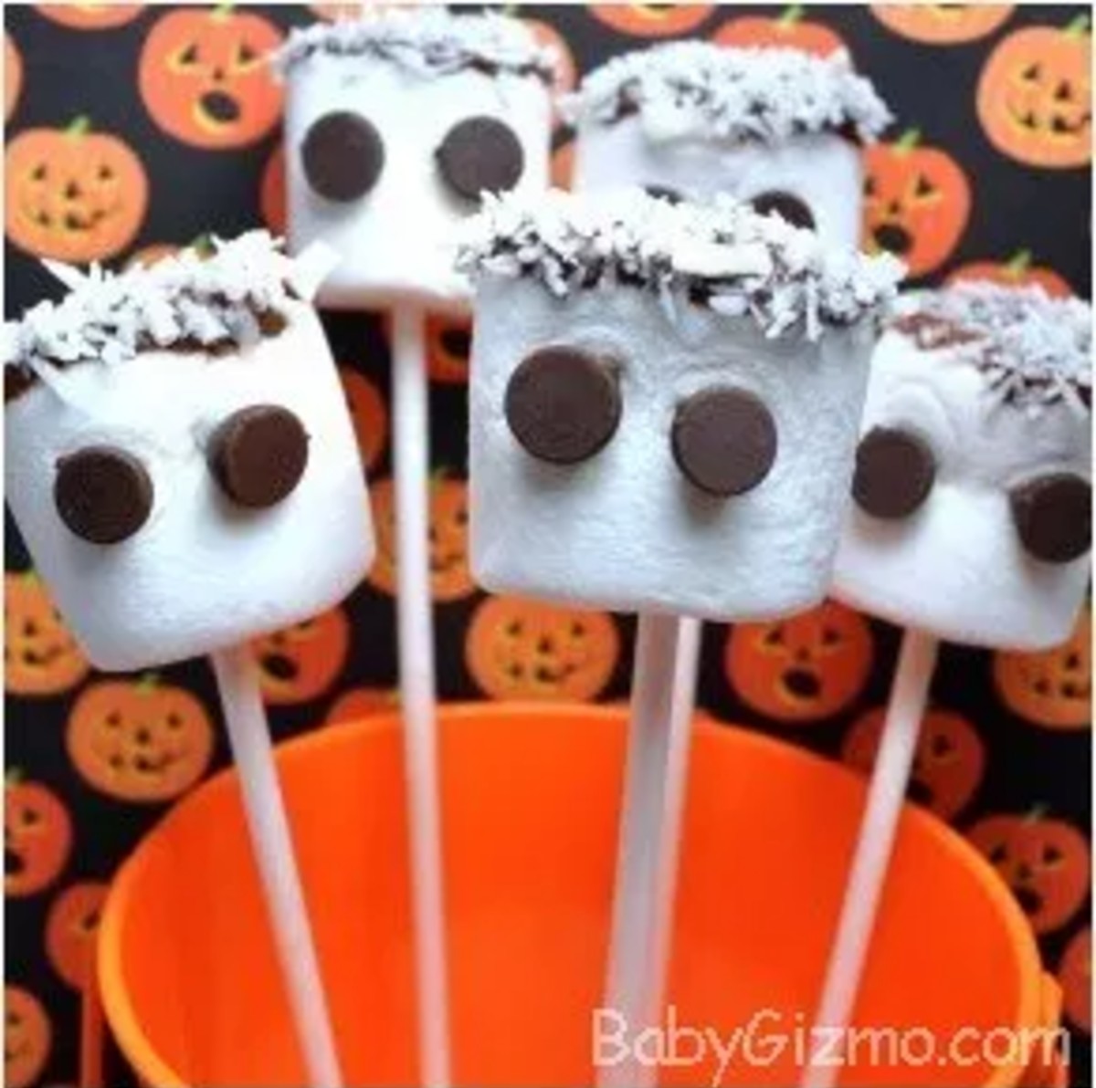 marshamallowghosts2 marshmallow ghost pops in an orange bucket with pumpkins in the background